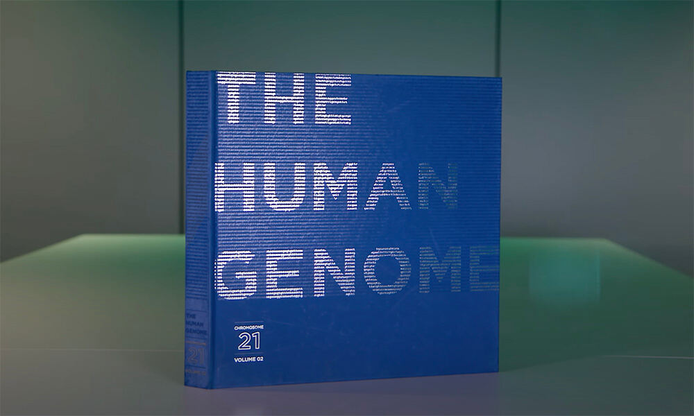 Blue book with title saying 'The Human Genome'