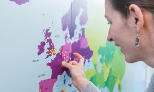 Amelie Baud, EMBL-EBI researcher, marks her journey on a map.

